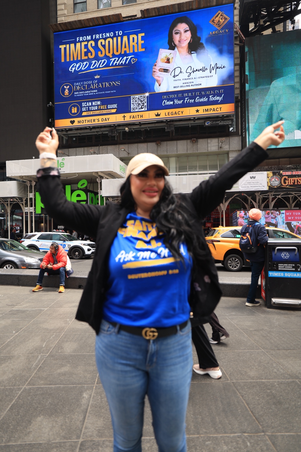 Shavelle Marie standing in Times Square beneath her featured billboard